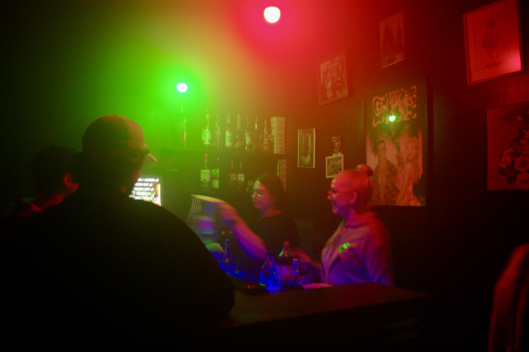 Bar scene with neon green and red lighting